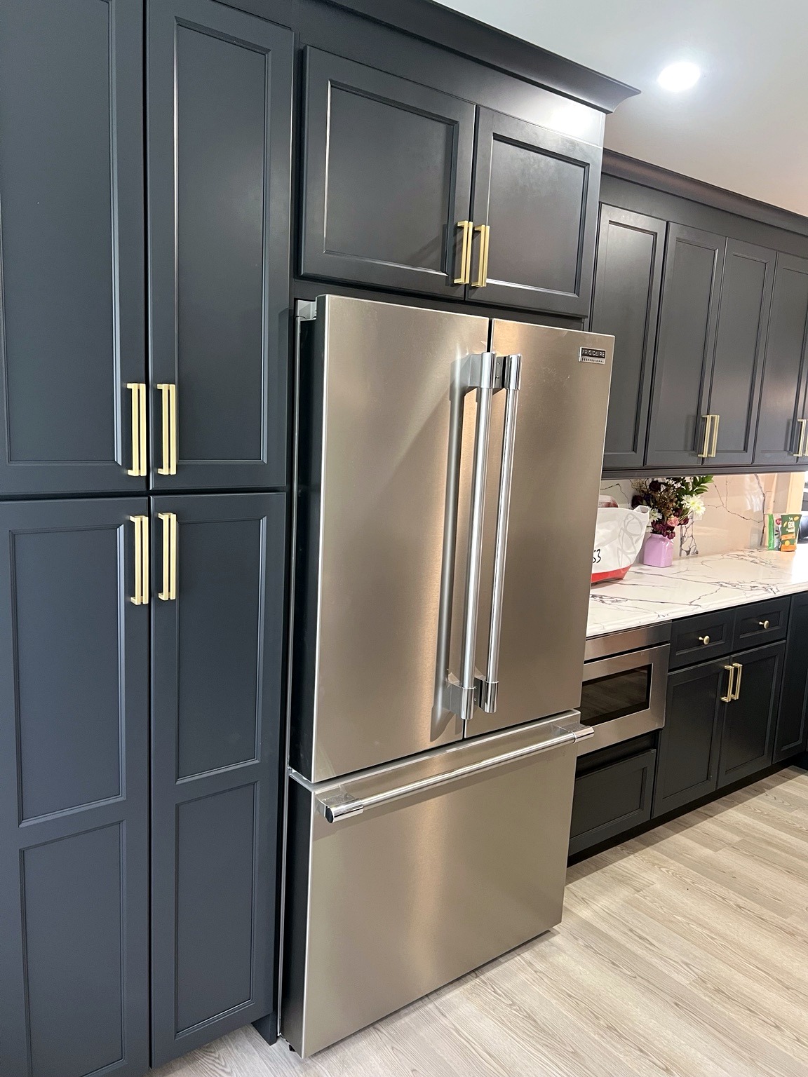 Custom-look dark kitchen cabinets and stainless steel appliances